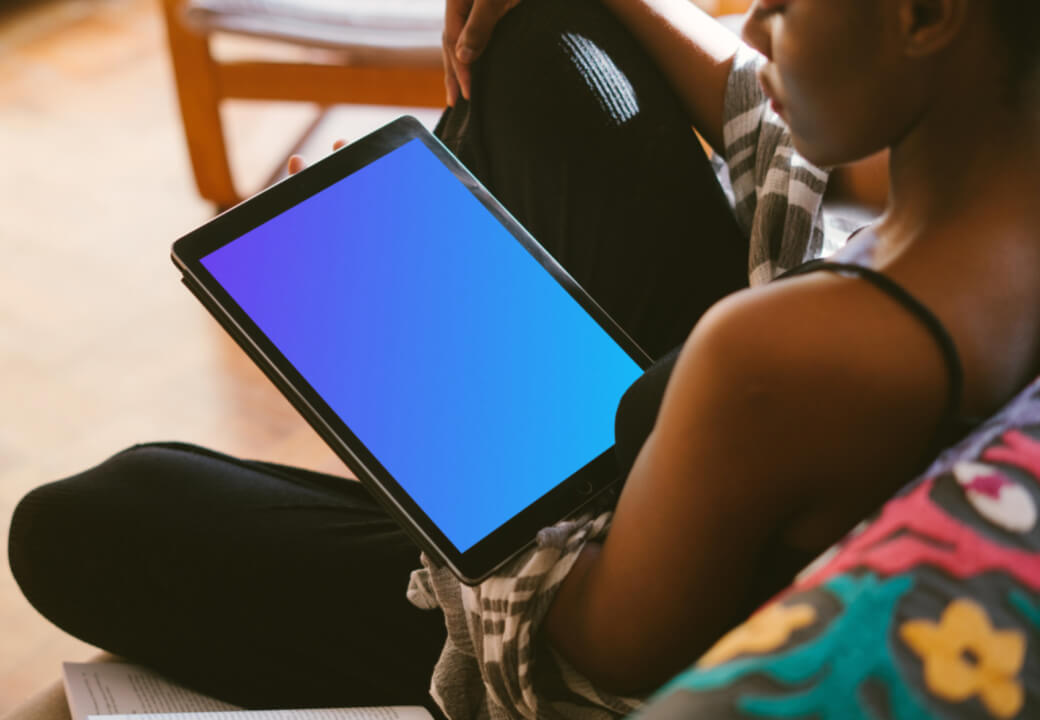iPad Pro mockup in dark-skinned black lady's hand for study