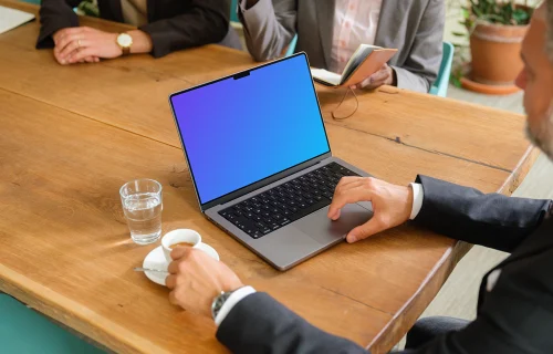 Businessman working on a MacBook during business meeting