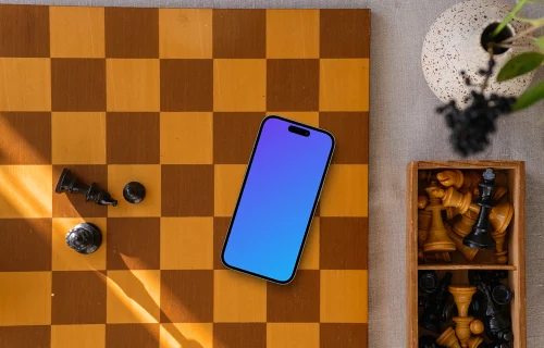 iPhone mockup deitado no tabuleiro de xadrez