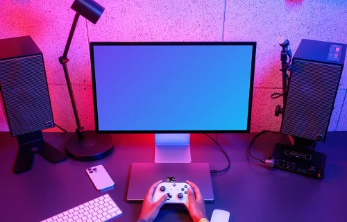 Gamer's desk with Apple Studio Display mockup and peripherals