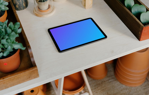 iPad Air mockup surrounded by potted plants on a white table