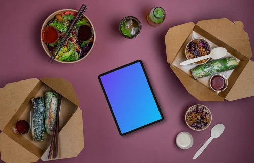 Tablet mockup surrounded by Asian food from delivery