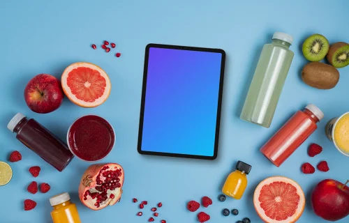 Tablet mockup surrounded by juices and fruit