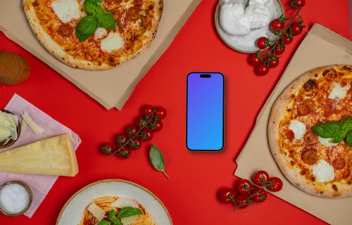 Telefone mockup entre caixas de pizza 