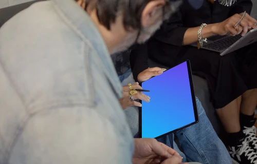 Microsoft Surface laptop mockup being used by two co-workers
