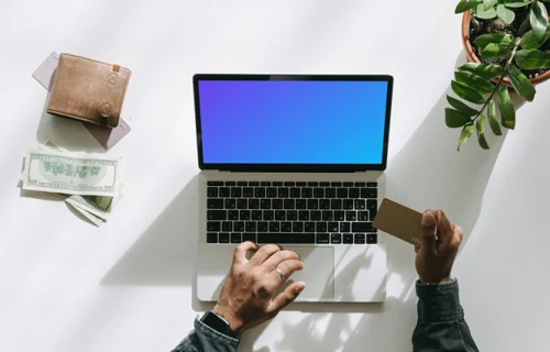 Mockup de Compras do usuário em um MacBook cinza ao lado de algum dinheiro e uma carteira